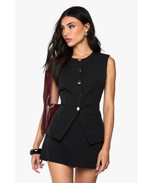 Sleek waistcoat-style top with distinctive button detailing
        Flattering peplum silhouette for a feminine touch
        Crew neckline for a classic, versatile look
        Sleeveless design perfect for layering or wearing solo
        Textured fabric adds depth and interest to the garment
    
    This chic waistcoat-style top is a must-have addition to your going-out wardrobe. The button detailing and peplum silhouette create a figure-flattering look that's both stylish and sophisticated. For a night on the town, pair it with high-waisted trousers and strappy heels to create a sleek ensemble that's sure to turn heads. Alternatively, layer it over a crisp white shirt and team with tailored shorts for a smart-casual look that's perfect for after-work drinks. The versatile design allows for endless styling options, making it a key piece for the fashion-forward woman who loves to experiment with her look. Whether you're hitting the club or meeting friends at a trendy bar, this top will help you make a statement without compromising on comfort.