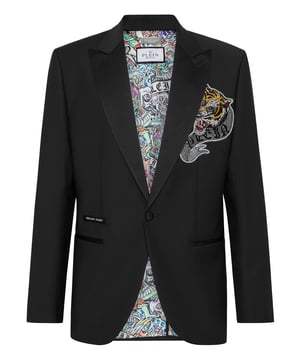 Add a spark to your wardrobe. Check out this wool canvas evening blazer with details that make it stand out.   Light wool canvas   Satin peak lapel   Rhinestoned patch sewn at left chest    Satin lined single button with embroidered Skull & Bones   Two satin trim finished slit pockets   Single vent   Inner lining