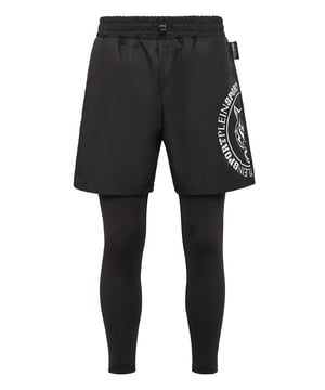 These 2-in-1 training pants are designed for jogging and achieve your goals in the best condition. Comfort and performance add up to the style of Plein Sport.   Matte nylon shorts and stretch cotton jersey leggings   The iconic Tiger print on both legs   Elasticated waistband with drawstring   Two slit pockets   Rubberized patch with Logo sewn on left leg
