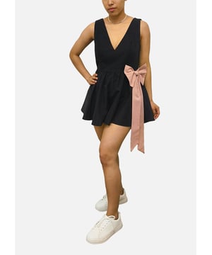 Effortlessly chic and comfortable, our Black Bow Detail Puff Skirt Playsuit is a must-have for your stylish wardrobe. Featuring a sleek black design with a playful bow detail and a flattering puff skirt, this playsuit is perfect for any occasion. Elevate your look with this versatile piece.