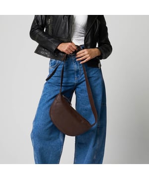 Everyday style with this beautifully crafted cross body bag in rich ruby chocolate brown. Made from supple real goat leather, this bag features a secure zip closure and an adjustable strap for a comfortable, custom fit. Compact and stylish, it’s perfect for carrying your daily essentials with ease and sophistication.