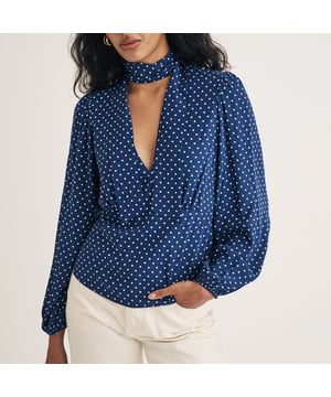 Spot on. Made entirely from responsible viscose  this floaty blouse comes in a vintage-inspired blue and white polka dot print. We love the tie fastening at the neck and the panelled waist that’s designed to flatter. Wear with white denim for that effortless “I just threw this togetherin look.• V-neck• Long balloon sleeves• Tie neck fastening• Panelled waist designed to flatter