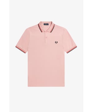 The Twin Tipped Fred Perry Shirt. Made from our classic cotton piqué, in a contemporary adaptation of Fred's famous streamlined fit. Available in a diverse range of colourways - each with their own unique story. See the Read More section for this product’s key responsible features. Cotton piqué / Regular fit / Slightly slimmer proportions than the original M12 / Twin tipped collar and cuffs / New two button set-in placket Our twin tipped piqué shirt was the first to carry our legendary tipping in the 5-4-4 ratio, and it remains at the core of everything we do. An interpretation of our original Twin Tipped Fred Perry Shirt, the M3600 offers a more contemporary adaptation of Fred's famous streamlined fit, with a slightly closer fit. Manufactured on state of the art, modern technology and available in a huge range of colours - each with their own unique story to tell. It comes with a history, and each new generation adds to its legacy. Always different, always the same. We're looking at ways to reduce our impact on the planet. This product is made with the following key responsible features: Recycled Tipping & Sewing Threads Buttons Made from Recycled Materials Responsibly-Sourced Laurel Wreath Embroidery To find out more, head to our Community page. Fred Perry is a proud member of Better Cotton. By choosing our cotton products, you’re supporting Fred Perry's investment in Better Cotton’s mission. 100% Cotton Machine Wash Style M3600