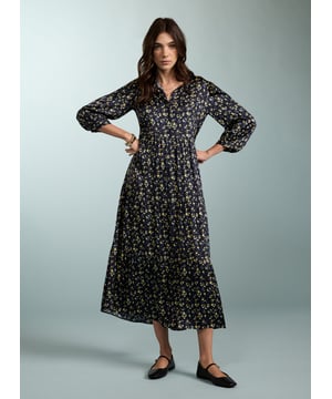 Description\nPurnita brings together details from our most popular dresses, such as a simple, throw-on shape with a tiered skirt, a button-down front, and of course - pockets! Its blurred ditsy print is so easy to style - see for yourself with leather biker or denim jackets, and any kind of footwear.  \n\nMade in Europe\nCrafted in a recycled satin blend \nElbow length sleeves with button fastening \nButtons to the waist seam \nMidi length \n\n\nSustainable Attributes:\n  Low impact \n   Low Water Use\n    Recycled Fibres \n   Ethically made\n   Vegan \n   \n\nDetails\nModel is 5'10 (177cm) and is wearing a UK 1049% LENZING™ ECOVERO™ Viscose, 51% Recycled ViscoseDelicate Machine Wash 30˚Product code: DR40568-BUDBack shoulder at neck to hem - 125cm (49 3/8)Sleeve length - 55cm (21 5/8)