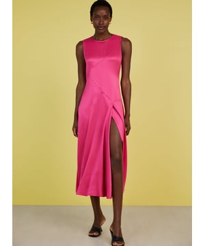 Description\nFits smaller to size, we suggest sizing up from your usual size\nPrepare to turn heads in Soleil! This feelgood frock comes in the most dazzling shade of pink, and a wonderfully resourceful fabric called Ecojilin, which makes use of recycled fibres. The result is a drapey dress with a luxe, satin finish and a sexy split for good measure. Just add heels and earrings and you’re ready to wow! \n\nCrafted in Ecojilin using recycled cotton fibres \nLong midi length\nDiagonally-cut seams for shaping\nSkims the waist and hips then flares out\nFastens with a button to the rear neck\nSide seam zip\n\n\nSustainable Attributes:\n Made in Europe   Low Impact  Low Water Use  Recycled Fibres  Ethically made   Vegan   Low Carbon  \n\nDetails\n100% Ecojilin ViscoseDry Clean OnlyProduct code: DR40493-HYPBack shoulder at neck to hem - 129cm (50 3/4)