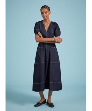 Description\nCoralie is a denim dress you can wear year-round: style it with bare legs and ballet pumps on milder days, then layer it with knee-high boots and a rollneck come winter. Crafted in raw, organic denim and defined by contrast stitching. An elasticated back panel is cut for a waist-accentuating fit and flare shape. Voluminous bell sleeves, and front zip opening top this contemporary design off.\n\nMade in Europe\nCrafted in organic cotton denim\nPockets\nContrast stitching\nBack elastic panel detail for shaping and fit\n\n\nSustainable Attributes:\n  Low Impact   Low Water Use   Natural fibres   Organic   Ethically made   Low Carbon \n\nDetails\nModel is 5'10 (177cm) and is wearing a UK 10100% Organic Cotton Delicate Machine Wash - 30°Product code: DR40576-DARBack shoulder at neck to hem - 123cm (48 3/8)Sleeve length - 31cm (12 1/4)