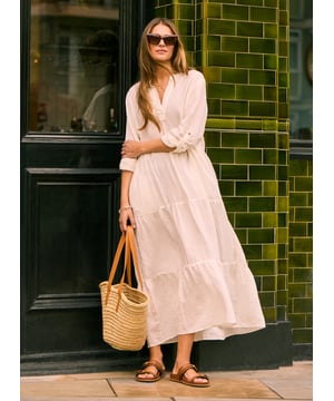 Description\nWe’ve given the classic shirt dress a relaxed, linen makeover for warm weather. Brenda features a notched collar with placket and is softened with a tiered, floaty skirt. On the full-length sleeves we’ve included tabs, so they’re easy to roll up. It’s your must-have for summer in the city - and on holiday. \n”My favourite dress for summer. Cool in white, happy in emerald” - Baukjen\n\nMade in Europe\nCrafted in linen\nPockets in side seams\nSimply pulls on \n\n\nSustainable Attributes:\n\n\n Low Water Use\n\n Natural fibres\n\n Ethically made\n\nDetails\nModel is 5'10 (177cm) and is wearing a UK 10\n100% Linen \nDelicate Machine Wash - 30°\nProduct code: DR40594-SFW \nBack shoulder at neck to hem - 129cm (50 3/4)\nSleeve length - 41cm (16 1/8)