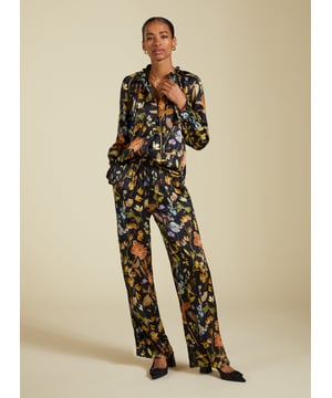 Description\nFits true to size, we suggest ordering your usual size.\nInject a little fun into your trouser collection with the Mandy Satin Trousers. This style boasts a beautiful botanical print on a black base, lending interest to crisp white blouses and oversize tees. But our favourite way to style them is with the matching Jasmine Satin Blouse for a considered co-ord. Cut for a wide-leg, pyjama-style silhouette, they are the ultimate spring-in-your-step piece.\n\nMade in Europe\nCrafted in a recycled satin blend\nElasticated waist with draw-cord\nSide slash pockets and back patch pockets\nWide-leg, relaxed fit\nBlack piping detail down each leg\nMatching shirt available\n\n\nSustainable Attributes:\n  Low Impact   Low Water Use  Ethically made  Low Carbon  \n\nDetails\nModel is 5'10 (177cm) and is wearing a UK 1049% Lenzing™ EcoVero™ Viscose, 51% Recycled ViscoseDelicate Machine Wash - 30°Product code: TR40313-BTOInside leg - 77.5cm (30 1/2)