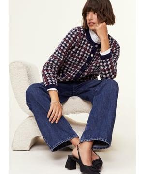 Description\nFits true to size, we suggest ordering your normal size.\nIs the Prudence a jacket or a cardigan? That’s your call, depending on how you style it! Wear it on its own with a mini skirt, or over a ruffle-collar blouse with jeans - the potential is limitless. Its classic houndstooth pattern in navy blue and beige is offset with an orange for a contemporary pop of colour.\nInspired by a family heirloom, Prudence is designed to give a little texture and joy to any outfit. Wear as a jacket or cardigan. I love how versatile it is. - Natalie, Design Director\n\nCrafted in a recycled wool blend\nBoxy fit\nFaux pockets\nSilver buttons\n\n\nSustainable Attributes:\n Made in Europe  Low Water Use   Mulesing free   Recycled Fibres  Ethically made   Raw Material Traced \n\nDetails\nModel is 5'10 (177cm) and is wearing a UK 1045% Merino Wool, 35% GRS Recycled Wool, 20% GRS Recycled NylonHand Wash Or Dry Clean OnlyProduct Code: KW40252-NANBack shoulder at neck to hem - 55cm (21 3/4)Sleeve length - 60cm (23 5/8)