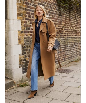 Description\nFits true to size, we suggest ordering your usual size.\nThe Ingrid Belted Trench Coat is a buy-now, wear-it-forever sort of wardrobe staple. Crafted in a heavy, recycled twill wool blend, it takes all its styling cues from the classic trench coat. Expect a double-breasted silhouette, epaulettes, storm flap and a belt. Beautifully cut and fully lined, it will elegantly elevate any outfit while offering maximum warmth. Whether it’s for weekdays or weekends, Ingrid can do it all. \n\nMade in Europe \nCrafted in a premium recycled wool blend \nTabs on cuffs \nFull length \nWelt pockets \n\n\nSustainable Attributes:\n\n\n Low Impact \n\n Low Water Use \n\n Mulesing free \n\n Natural fibres \n\n Recycled Fibres \n\n Ethically made \n\n\nDetails\nModel is 5'10 (177cm) and is wearing a UK 10\n65% Recycled Wool, 30% Recycled Polyester, 5% Other Fibres\nDry CLean Only\nProduct Code: OT40103-TAU \nBack shoulder at neck to hem - 120cm (47 1/4)\nSleeve length - 60cm (23 5/8)