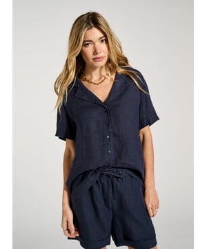 Description\nPyjama-inspired shirting + cooling linen = the ultimate summer top! Ethel is an effortless alternative to a tee; its open collar will elevate your favourite jeans or linen trousers on one easy move. For a fun, full look, pair it with the co-ordinating Marlow Shorts in the same shade of indigo. \n\nMade in Europe\nCrafted in pure linen \nRelaxed fit \nButtons through  \nMatching shorts available \n\n\nSustainable Attributes:\n\n\n Low Water Use\n\n Natural fibres\n\n Ethically made \n \n Vegan  \n\nDetails\nModel is 5'10 (177cm) and is wearing a UK 10\n100% Linen \nDelicate Machine Wash - 30°\nProduct code: SH40280-DPI \nBack shoulder at neck to hem - 63cm (24 7/8)\nSleeve length - 20cm (7 7/8)