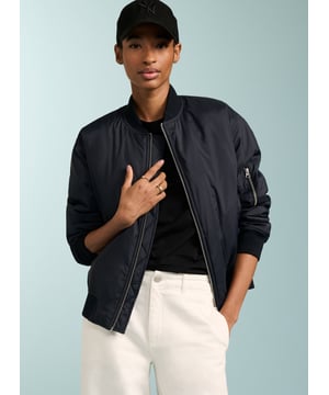 Description\nFeatured in The Times.\nMy favourite (bomber) is from Baukjen, made from recycled fibres. Pair it with jeans, sure, but also – to keep things really up to date – with tailoring, or even evening wear. It’s the perfect sartorial slam dunk. - Anna Murphy, Fashion Director, The Times\nFits true to size, we suggest ordering your usual size.\nWe’re loving our Tegan Bomber jacket. Proudly crafted in recycled fibres, our zip-down bomber jacket is the ultimate lightweight layer, and the perfect partner to so many looks. Tegan features a zip patch pocket on one sleeve, front welt pockets and an internal breast pocket for your valuables. We’ve designed it slightly oversized for that cool, effortless look. Enjoy this for years.\n\nMade in Europe\nCrafted in 100% recycled fibres\nZip patch on sleeve\nSide pockets\n\n\nSustainable Attributes:\n  Low impact  Low Water Use  Recycled Fibres  Ethically made   Vegan    Low Carbon \n\nDetails\nModel is 5'10 (177cm) and is wearing a UK 10100% Recycled PolyesterHand wash Or Dry clean OnlyProduct code: OT40076-NAVBack shoulder at neck to hem - 61cm (24)Sleeve length - 59cm (23 1/4)