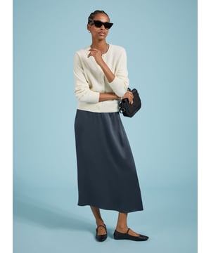 Description\nFits true to size, we suggest ordering your usual size.\nSlip skirts are enjoying a moment, and Doris is the easiest and most impactful style to update your wardrobe with. Crafted in satin-back crepe Ecojilin viscose, this style comes in a simple column shape, and features hidden elastic in the back of the waistband for comfort. In classic navy, it will add a considered twist to plain white tees or jumpers, and can easily be dressed-up with a blouse or camisole for nights out.\n\nMade in Europe\nCrafted in responsibly sourced Ecojilin viscose \nLong length\nFastens with an invisible side zip\nHidden elastic at back waist\n\n\nSustainable Attributes:\n  Low impact  Low Water Use   Recycled Fibres   Ethically made  Low Carbon \n\nDetails\nModel is 5'10 (177cm) and is wearing a UK 10100% Ecojilin ViscoseDry Clean OnlyProduct Code: SK40199-CLNCentre back waist to hem - 84cm (33)
