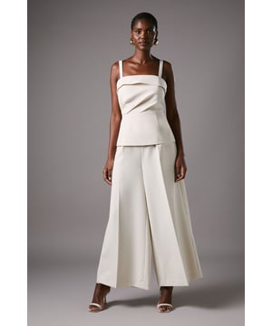 Elegant crop trousers featuring sophisticated front pleats for added dimension and structure
        Wide-leg silhouette offering graceful movement and contemporary sophistication
        Flattering high-waist design that accentuates the natural waistline
        Crafted from crepe fabric with a touch of stretch for comfort throughout the day
        Versatile 72cm inside leg length, perfect for showcasing statement footwear
    
    These exquisite crop trousers from Coast present a masterclass in refined occasion dressing. The architectural pleating creates a fluid silhouette that commands attention whilst maintaining an air of understated elegance. Style with the coordinating top as shown for a modern take on formal attire, or pair with a delicate lace blouse for traditional sophistication. The wide-leg design offers both comfort and visual impact, making these trousers ideal for summer weddings, race day events or graduation ceremonies. Complete your ensemble with strappy heeled sandals and a structured clutch for a polished finish. The clean lines and impeccable tailoring reflect Coast's commitment to creating pieces that help you look your absolute best for those moments that matter most.