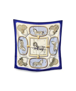 VINTAGE, RRP AS NEW
Vintage Hermès Scarf by Jacques Eudel - Issued 1962  A collector's treasure from the golden age of Hermès design, this exquisite silk scarf by Jacques Eudel was first issued in 1962 and showcases the maison's deep-rooted connection to the equestrian world. Known for his detailed and lifelike renderings, Eudel brings the traditions of horsemanship to life in this timeless composition.  Set in a refined palette of blue, light blue and beige, the design captures the elegance and discipline of equestrian culture-each element carefully illustrated with a sense of motion and mastery. Measuring approximately 35 x 35 inches (88.9 x 88.9 cm), the scarf is crafted in France from 100% silk and finished with classic hand-rolled hems.  Marked HERMÈS PARIS - Made in France, this piece is not just a scarf-it's a wearable work of art from the storied archives of Hermès. Condition Rating: A - EXCELLENTCondition Details: Gently used. Hermes box included. Hermes composition tag still attached. Please check the photos carefully and ask if you need to know more details or if you have any doubts.  Box?: Yes Measurments:  length: 889 mm height: 889 mm