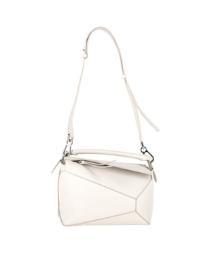 VINTAGE, RRP AS NEW
The Loewe Puzzle Small Bag in white calfskin is a sculptural masterpiece defined by its signature geometric panels and cuboid silhouette. Crafted in smooth calfskin with meticulous single-stitch detailing, it features a detachable, adjustable strap for shoulder, crossbody, or hand carry. Functional yet distinctive, it’s finished with an embossed Anagram and lined in soft herringbone cotton.
Loewe Puzzle Small Bag in White Calfskin Leather
Condition: Excellent
Signs of wear: No retail tag, No visible sign of wear., 
Packaging: Dust bag
Color: White | ecru
Material: Leather | calfskin leather
Size: One Size | One Size
Measurements: Width: 100; Height: 180; Length: 260; Handle drop: 5; Strap length: 0
SKU: 491679 / NAPPUGBBA475702W