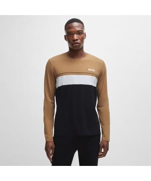 Men's Boss Long Sleeved Logo Print Pyjama T-Shirt. Pajama top from the BOSS collection. Model made of cotton knit fabric.- Classic round neckline.- Long sleeves.- Decorative seams.- Logo patch on the front.- Fine, elastic knit.- Heatseal Logo.- Contrast piping and inserts. Material: 55% Cotton, 37% Modal, 8% Elastane. Ref: 50527337001.