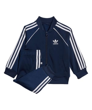 Infant adidas Originals Adicolor SST Track Suit in night indigo.Calling all future MVPs. Your star will win at sporty style in this infants' track suit. Level up their adidas game with iconic 3-Stripes and a hit of piping. That OG sheen of tricot adds the finishing touch. This track suit is made with Primeblue  a high-performance recycled material made in part with Parley Ocean Plastic.- A tricot track suit inspired by archive design.- Regular fit- Full zip with ribbed collar- 100% polyester (recycled)- Soft feel- Front welt pockets on jacket- Raglan sleeves- Elastic waist with drawcord- Primeblue- Ribbed cuffs and hem- Machine wash warm- Ref: HK7486