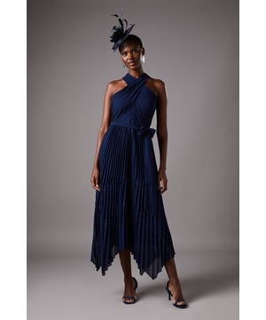 Elegant halterneck design with crossover detail for a sophisticated neckline
        Delicate lace inserts add a touch of feminine charm to the flowing silhouette
        Striking pleated chiffon skirt with asymmetric hemline for graceful movement
        Flattering waist tie detail to accentuate your figure
        Midi length with handkerchief hem creates a dramatic yet refined look
    
    This exquisite Coast dress embodies timeless elegance with its fluid pleated design and striking halterneck silhouette. The crossover bodice creates a flattering frame while the asymmetric handkerchief hem adds contemporary flair to this occasion piece. Style with strappy heels and statement earrings as shown for race day sophistication, or pair with an embellished clutch for wedding guest perfection. The lightweight chiffon fabric moves beautifully with every step, ensuring you'll command attention at any formal gathering. For cooler evenings, complement with a tailored blazer or delicate wrap. This versatile dress transitions effortlessly from daytime celebrations to evening affairs, making it a treasured addition to your occasion wardrobe.