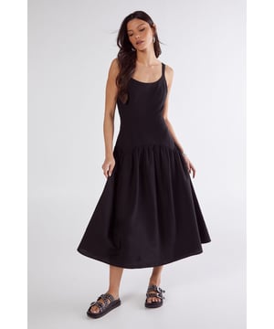 Linen mix fabric for breathable comfort and natural texture
        Flattering drop waist seam design creating a relaxed silhouette
        Elegant scoop neckline complementing the dcolletage
        Striking open back with delicate tie detail for added interest
        Midi length with full skirt for effortless movement
    
    This captivating drop waist midi dress from Nasty Gal combines casual charm with distinctive design elements. The linen mix fabric offers a natural drape that flows beautifully with every step, while the seamed construction creates a relaxed yet defined silhouette. The standout feature is the alluring open back with tie fastenings, adding an unexpected twist to this daywear essential. Style with chunky sandals as seen on our model for a laid-back weekend look, or dress up with espadrille wedges and statement earrings for garden parties and brunches. The versatile midi length works brilliantly for family gatherings and casual outings, whilst the cotton lining ensures comfort throughout the day. This dress transitions seamlessly from city strolls to countryside escapes, making it a wardrobe staple for the warmer months.