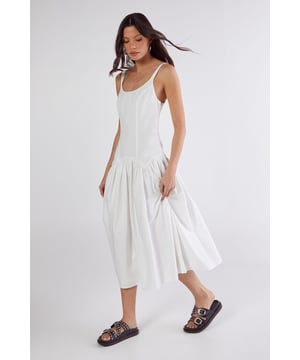 Linen mix fabric for breathable comfort and natural texture
        Flattering drop waist seam design creating a relaxed silhouette
        Elegant scoop neckline complementing the dcolletage
        Striking open back with delicate tie detail for added interest
        Midi length with full skirt for effortless movement
    
    This captivating drop waist midi dress from Nasty Gal combines casual charm with distinctive design elements. The linen mix fabric offers a natural drape that flows beautifully with every step, while the seamed construction creates a relaxed yet defined silhouette. The standout feature is the alluring open back with tie fastenings, adding an unexpected twist to this daywear essential. Style with chunky sandals as seen on our model for a laid-back weekend look, or dress up with espadrille wedges and statement earrings for garden parties and brunches. The versatile midi length works brilliantly for family gatherings and casual outings, whilst the cotton lining ensures comfort throughout the day. This dress transitions seamlessly from city strolls to countryside escapes, making it a wardrobe staple for the warmer months.