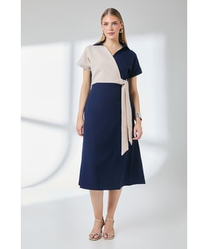 Striking colour block design with elegant wrap neckline
        Flattering side tie detail that cinches the waist
        Midi-length silhouette with a graceful A-line shape
        Short sleeves with neat collar for a smart-casual finish
        Lightweight woven fabric with a touch of stretch for comfort
    
    This sophisticated Principles wrap dress combines contemporary style with everyday wearability. The contrasting colour block design creates visual interest while the side tie detail accentuates your waistline beautifully. Perfect for daytime occasions, style with nude strappy sandals as shown for family gatherings or weekend brunches. For a more casual approach, pair with white trainers and a denim jacket. The versatile midi length works wonderfully for garden parties or casual office days. Add a simple crossbody bag and delicate jewellery to complete your look. The slight stretch in the fabric ensures all-day comfort without compromising on structure, making this dress a wardrobe essential that transitions effortlessly from morning coffee dates to afternoon shopping trips.
