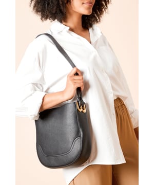 Sleek faux leather shoulder bag with a complementary detachable pouch
        Distinctive gold-tone hardware detailing for a touch of elegance
        Curved silhouette with textured finish for added visual interest
        Comfortable shoulder strap with adjustable length for versatile wear
        Spacious main compartment with additional interior pockets for organisation
    
    The Berlin Shoulder Bag from Dorothy Perkins offers the perfect blend of practicality and style for your everyday adventures. The curved silhouette creates a contemporary look whilst the textured faux leather finish adds sophistication to any outfit. Wear it casually slung over your shoulder with a crisp white shirt and tailored trousers for brunch with friends, or pair with a floaty midi dress for family gatherings. The detachable pouch is brilliantly versatile - use it separately for essentials when you need to travel light or keep it inside to organise your belongings. The adjustable strap ensures comfortable wear throughout the day, making this the ideal companion for shopping trips, coffee dates or casual weekend outings. Available in different colourways to complement your wardrobe, this bag will quickly become your go-to accessory for any casual occasion.