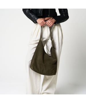 Add effortless elegance to your everyday wardrobe with this beautifully understated suede shoulder bag from Barneys Originals. Crafted from 100% real cow suede, this slouchy silhouette is soft to the touch and perfect for summer styling. 

Designed with practicality in mind, this bag features an adjustable shoulder strap and a roomy interior for all your essentials. The worn-effect gold hardware adds a timeless touch that only gets better with age.

Key Features:

Made from 100% real cow suede

Soft, unstructured shape for a relaxed feel

Adjustable shoulder strap with gold-tone hardware

Magnetic fastening for easy access

Spacious enough for your everyday must-haves

Dimensions:
Height: 10" (25.4 cm)
Width: 15" (38.1 cm)
Handle Drop: 13" (33 cm)