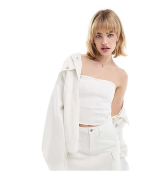 Tops by Calvin Klein Jeans  Skirt and jacket sold separately Bandeau style Logo patch to back Zip fastening Slim fitSold By: Asos