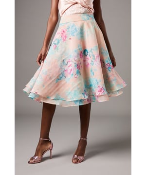 Ethereal organza fabric with delicate floral print throughout
        Elegant midi length with a graceful A-line silhouette
        Double-layered design creating beautiful movement when walking
        High-waisted fit with a flattering waistband
        Fully lined for comfort and structure
    
    Make a statement at your next special occasion with this enchanting organza midi skirt from Coast. The dreamy floral pattern dances across the lightweight, semi-sheer fabric, creating an air of refined femininity. Style with a satin camisole as shown for a coordinated ensemble, or pair with a fitted blouse for a more structured look. The flowing layers catch the light beautifully as you move, making it perfect for summer weddings, garden parties or race day events. Complete your look with strappy heels and delicate jewellery for an ensemble that captures attention for all the right reasons. The versatile midi length works wonderfully for both daytime celebrations and evening soires, ensuring this skirt becomes a treasured piece in your occasion wardrobe.