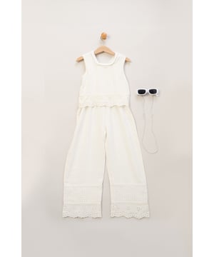 Perfect for holidays and summertime events, this adorable broderie jumpsuit by Miss features a playful scalloped edge design and crotchet panel. The set comes with matching sunglasses, creating a fun and stylish outfit that's both comfortable and versatile for sunny days.