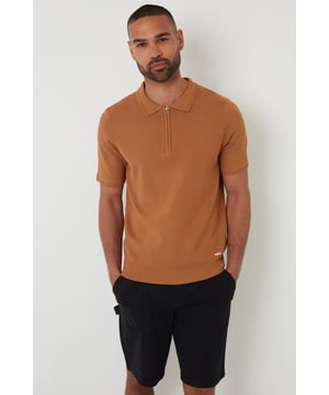 Your casual classics get a makeover with this zip-neck knitted polo shirt from Threadbare. In an all-over jersey stitch, the cuffs and hem are finished with a subtle rib with textured trim detail. This knitted polo has a stylish concealed quarter zip and ribbed collar with textured trim for an elevated touch and is finished with a branded metal tab above the hem. Pair it with chinos or jeans for day-to-day wear that also works perfectly for date night, or team with shorts for summer style.