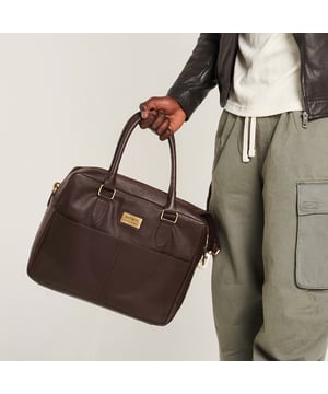 – Real leather
– Detachable shoulder strap
– Two zipped compartments
– Velcro laptop sleeve
– 14″ x 12″ x 4.5″

Commute in style with this brown leather messenger bag from Barneys Originals. Made from durable real leather, this sleek everyday essential is perfect for carrying your tech, with a padded Velcro laptop sleeve and handy inner zip pocket.

With two zipped sections to keep things organised, you can switch between the top handles and detachable shoulder strap depending on your day. Whether you’re heading to the office or a café, this bag has your back.