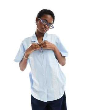 Tops by Reclaimed Vintage  Revere collar Button placket Chest pocket Regular fitSold By: Asos