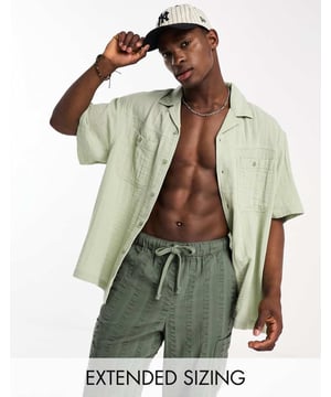 Shirts by ASOS DESIGN Add-to-bag material Revere collar Button placket Chest pockets Short sleeves Oversized fitSold By: Asos