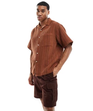 Shirts by ASOS DESIGN Waist-up dressing Stripe design Revere collar Button placket Chest pocket Oversized fitSold By: Asos