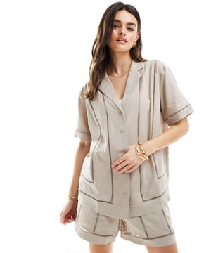 Tops by ASOS DESIGN Summer, styled Revere collar Button placket Short sleeves Ladder trims Relaxed fitSold By: Asos