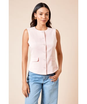 Sleeveless tailored design with a clean crew neckline for a sophisticated silhouette
        Decorative button-up front detail adds a refined touch to this versatile piece
        Structured woven fabric with slight stretch for comfortable all-day wear
        Subtle front pocket detail provides both functionality and style
        Flattering tailored fit that gently contours the body without being restrictive
    
    This Dorothy Perkins tailored button-up top offers the perfect balance between polished style and everyday comfort. The sleeveless design makes it ideal for layering under blazers during cooler months or wearing on its own for warmer days. Style it as shown with relaxed denim jeans and neutral footwear for casual brunches with friends, or pair with tailored trousers and ballet flats for family gatherings. The structured silhouette creates a put-together look that transitions seamlessly from day to evening occasions. For a contemporary twist, layer over a fine-knit turtleneck with wide-leg trousers, or tuck into a flowing midi skirt for baby showers and afternoon teas. Machine washable for easy care, this versatile top will quickly become a cornerstone of your smart-casual wardrobe.