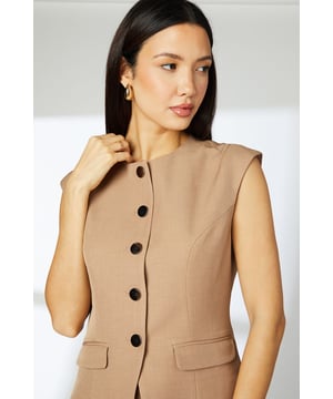 Sleek tailored waistcoat with distinctive cap sleeves for a contemporary silhouette
        Clean crew neckline complemented by statement button-through front closure
        Practical front pockets add functionality without compromising the streamlined design
        Subtle back detail with decorative buttons for added interest
        Regular fit offering comfortable movement whilst maintaining a polished appearance
    
    This versatile Principles waistcoat brings modern sophistication to your daywear collection. The clean lines and cap sleeve detail create a refined yet relaxed silhouette that works beautifully for various casual occasions. Style with the matching wide-leg trousers as shown for an effortlessly coordinated look, or pair with slim-fit denim and trainers for a smart-casual weekend ensemble. The structured woven fabric provides just enough stretch for all-day comfort, making it ideal for family gatherings or lunch with friends. Add simple gold-toned jewellery and a structured tote for a polished finish. This piece transitions seamlessly from day to evening - simply swap your flats for a block heel and add a bold lip colour for after-work drinks or dinner dates.
