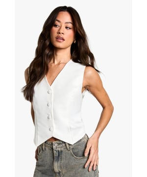 Sleek V-neck design for a flattering neckline
        Boxy fit for a contemporary silhouette
        Button-front closure adds a classic touch
        Versatile sleeveless style perfect for layering
        Cropped length ideal for high-waisted bottoms
    
    Embrace effortless chic with this essential waistcoat, a must-have addition to your wardrobe. The boxy fit offers a modern twist on a timeless classic, while the V-neck design creates a flattering frame. Style this versatile piece for a range of casual occasions, from family gatherings to laid-back brunches with friends. Layer it over a crisp white shirt and pair with wide-leg trousers for a polished look, or throw it on over a simple tee with your favourite jeans for an effortlessly cool ensemble. The cropped length works beautifully with high-waisted bottoms, creating a balanced silhouette. Accessorise with delicate gold jewellery and a small handbag to complete your look. This waistcoat is the perfect blend of comfort and style, ensuring you'll reach for it time and time again.