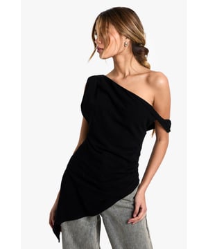 Striking one-shoulder design with elegant draping detail
        Asymmetric hemline creates a contemporary silhouette
        Soft linen-blend fabric offers comfort with a refined finish
        Versatile piece that transitions effortlessly from day to evening
        Flattering fit that accentuates the shoulder and dcolletage
    
    Make a statement with this beautifully draped one-shoulder top that combines contemporary design with effortless style. The asymmetric neckline and hemline create visual interest whilst the linen-blend fabric ensures comfort throughout the day. Style with relaxed trousers as seen on our model for a balanced silhouette that works perfectly for casual gatherings or weekend brunches. For evening occasions, pair with tailored trousers and statement earrings. Add a structured clutch and strappy heels to transform this versatile piece into an outfit worthy of dinner dates or gallery openings. The draped detail adds movement and dimension, making this top a standout addition to your wardrobe that can be styled in multiple ways across seasons.
