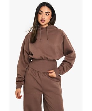 Ribbed texture for added visual interest
        Gathered waist design for a flattering silhouette
        Oversized fit for ultimate comfort
        Long sleeves with ribbed cuffs for a snug fit
        Versatile hooded neckline for casual style
    
    Embrace laid-back chic with this ribbed hoodie featuring a gathered waist, perfect for those who crave comfort without compromising on style. The oversized fit offers a relaxed vibe, ideal for lounging at home or running errands in the city. Style it with wide-leg trousers and trainers for a trendy athleisure look, or pair it with your favourite leggings for a cosy night in. The versatile design makes it suitable for casual outings, from coffee dates to weekend shopping trips. Layer it under a denim jacket for cooler days or wear it solo for a simple yet fashionable ensemble. This hoodie is a must-have staple that will quickly become your go-to for effortless, everyday wear.