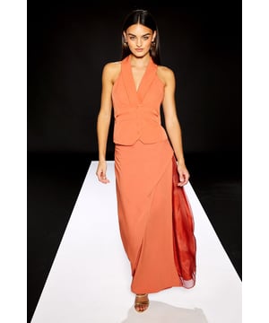 Striking maxi skirt featuring contrasting organza panels for a contemporary silhouette
        Asymmetric wrap-style design creates elegant movement with every step
        Floor-sweeping length offers dramatic flair for daytime sophistication
        Tailored waistband provides a flattering fit that sits comfortably at the natural waist
        Fully lined for smooth wear and optimal comfort throughout the day
    
    Make a statement in this RUNWAY 1.8.1.8 maxi skirt, where structured twill meets delicate organza for a captivating textural contrast. The asymmetric design with sheer panels creates visual interest whilst maintaining an effortless daytime aesthetic. Style with a fitted halterneck top as shown for a coordinated look, or pair with a simple tucked-in blouse for versatile styling options. This skirt transitions beautifully from casual brunches to gallery visits-simply switch between metallic sandals and white trainers depending on the occasion. The flowing silhouette moves gracefully with you, making it ideal for garden parties or alfresco dining when the weather permits. A true wardrobe hero for those who appreciate architectural details in their daywear collection.
