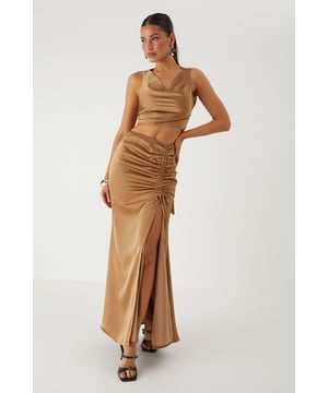 Luxurious satin co-ord featuring a flattering cowl neckline top and statement maxi skirt
        Elegant ruched detailing along the skirt front creates a figure-enhancing silhouette
        Daring side split in the maxi skirt adds movement and reveals just the right amount of leg
        Stylish tie-back detail on the top for an adjustable and secure fit
        Sleek crop top design pairs perfectly with the high-waisted maxi skirt for a contemporary two-piece look
    
    Make a striking entrance at your next special occasion in this showstopping satin co-ord from MissPap. The combination of the cowl neck crop top and ruched maxi skirt creates a contemporary silhouette that commands attention. Style with strappy heels and statement earrings as seen on our model for maximum impact at formal events. The high-waisted design of the skirt elongates your figure, whilst the side split adds a touch of drama to your movement. Perfect for weddings, graduation ceremonies or evening galas, this versatile co-ord can be dressed up with metallic accessories for a glamorous finish. For cooler evenings, layer with a tailored blazer without compromising on style. The satin fabric catches the light beautifully as you move, ensuring all eyes are on you throughout the night.