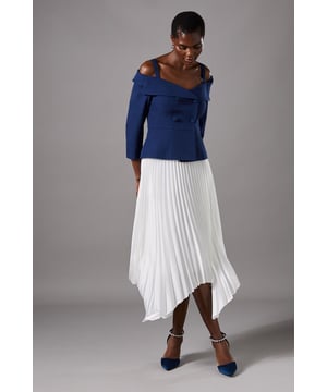 Luxurious satin finish with elegant pleating throughout
        Distinctive asymmetric hemline creating a graceful silhouette
        Fluid drape that moves beautifully with every step
        Mid-calf to ankle length design for sophisticated coverage
        Fully lined for comfort and optimal shape retention
    
    This Coast pleated satin skirt embodies refined elegance with its flowing asymmetric hemline and meticulous pleating. The fluid fabric catches the light beautifully as you move, creating a captivating visual effect perfect for special occasions. Style with a structured off-shoulder top as shown for a balanced silhouette, or pair with a delicate lace camisole for a softer approach. Complete your ensemble with pointed court shoes and pearl accessories for race day sophistication, or dress down slightly with a fitted cashmere jumper for elegant evening dining. The versatile design transitions seamlessly from daytime celebrations to evening events, making it an invaluable addition to your occasion wardrobe. The handkerchief hem adds contemporary flair to this timeless piece, ensuring you stand out for all the right reasons at your next important event.