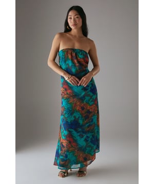 Flowing chiffon maxi dress with striking abstract print pattern
        Bandeau neckline with elasticated back for comfortable fit
        Flattering floor-length silhouette designed specifically for petite frames
        Lightweight, floaty fabric perfect for warm-weather occasions
        Elegant open back detail adds a touch of sophistication
    
    This captivating bandeau maxi dress from Warehouse combines effortless style with practical comfort. The elasticated back ensures a secure fit whilst allowing freedom of movement throughout the day. The lightweight chiffon fabric creates a graceful, flowing silhouette that's ideal for summer gatherings and casual daytime events. Style with metallic sandals and statement earrings as seen on our model for a relaxed yet put-together look. Alternatively, pair with a cropped denim jacket and flat sandals for family barbecues or weekend brunches. The versatile design makes it perfect for packing on holiday - simply add oversized sunglasses and a woven tote for beachside strolls or casual dining. This dress offers the perfect balance of comfort and style for the confident Warehouse woman who appreciates feminine silhouettes with an edgy twist.