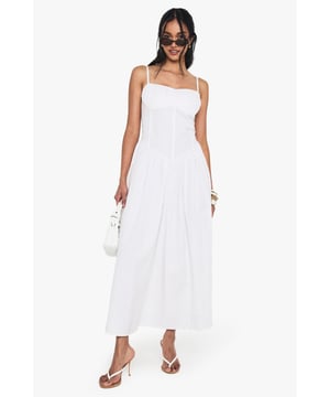 Crafted from breathable cotton poplin for all-day comfort
        Flattering milkmaid design with structured bodice and flowing maxi skirt
        Elegant sweetheart neckline to showcase your dcolletage
        Delicate adjustable shoulder straps for the perfect fit
        Ankle-grazing maxi length ideal for warm-weather styling
    
    This cotton milkmaid maxi dress captures effortless summer style with its classic silhouette and breezy appeal. The structured bodice creates a flattering shape while the sweetheart neckline adds a touch of feminine charm. Perfect for casual daytime events, style with flat sandals and a mini handbag as shown for a relaxed brunch with friends or family gatherings. For cooler evenings, layer with a lightweight denim jacket and accessorise with bangles for added interest. The versatile design transitions beautifully from garden parties to beachside strolls, making it a wardrobe essential for the warmer months. The cotton fabric ensures breathability whilst the maxi length offers a graceful movement that complements any casual occasion.
