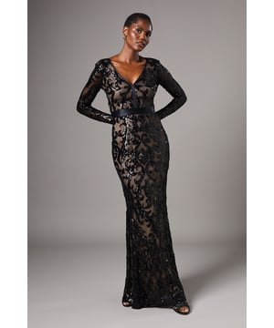 Striking sequin embellishment across intricate pattern detailing
        Elegant V-neckline frames the dcolletage beautifully
        Figure-enhancing maxi silhouette with floor-sweeping length
        Long sleeves offer sophisticated coverage for formal occasions
        Semi-sheer overlay creates a captivating contrast against the lining
    
    Make an unforgettable entrance in this show-stopping sequin maxi dress from Coast. The alluring V-neckline and body-contouring fit create a silhouette that commands attention, whilst the intricate pattern detailing adds depth and dimension to your look. Perfect for black-tie events, evening galas or wedding receptions, this dress requires minimal accessorising-simply pair with delicate drop earrings and a sleek clutch as seen on our model. The floor-length design creates a graceful sweep as you move, whilst the long sleeves provide an elegant balance to the striking neckline. Style with strappy heeled sandals and a tailored evening coat for cooler evenings. This dress transitions effortlessly from formal ceremonies to evening celebrations, ensuring you remain the epitome of sophistication throughout any special occasion.
