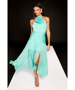 Striking corsage detail adorns the halter neckline for a dramatic, feminine touch
        Elegant maxi length with flowing georgette fabric that creates graceful movement
        Sophisticated high neck design balances the sleeveless silhouette beautifully
        Flattering side split adds a contemporary edge and ease of movement
        Fully lined for comfort and a flawless drape that maintains the dress's shape
    
    Make a statement at your next special occasion with this show-stopping halter neck maxi dress from Warehouse's exclusive RUNWAY 1.8.1.8 collection. The standout corsage detail creates a bold focal point that commands attention, whilst the flowing georgette fabric cascades elegantly to the floor, creating a sense of drama with every step. Style with metallic strappy heels and statement earrings as seen on our model for a refined evening look. Perfect for summer weddings, formal garden parties or race day events where sophistication is key. The clean lines and contemporary design reflect the confident, edgy aesthetic that Warehouse is renowned for, whilst maintaining a distinctly feminine appeal. The side split detail offers both practical movement and a subtle glimpse of leg for a modern finish.