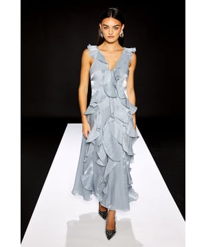 Dramatic cascading ruffles create a captivating silhouette from neckline to hem
        Elegant V-neckline at both front and back for a sophisticated reveal
        Lightweight chiffon fabric offers graceful movement with every step
        Sleeveless design with delicate ruffle detailing at the shoulders
        Maxi length provides a refined, floor-skimming profile perfect for formal occasions
    
    Make a striking entrance in this Runway 1.8.1.8 Ruffle V Neck Maxi Dress from Warehouse. The showstopping cascading ruffles create dimension and movement, whilst the flattering V-neckline frames your dcolletage beautifully. Style as seen with statement drop earrings and pointed court shoes for sophisticated wedding guest attire. For summer soires, pair with metallic strappy sandals and a structured clutch. The flowing chiffon fabric catches the light as you move, making this dress ideal for those moments when you wish to command attention. Perfect for formal events where you want to showcase your confident, feminine style without compromising on comfort-this dress offers both drama and wearability in equal measure.